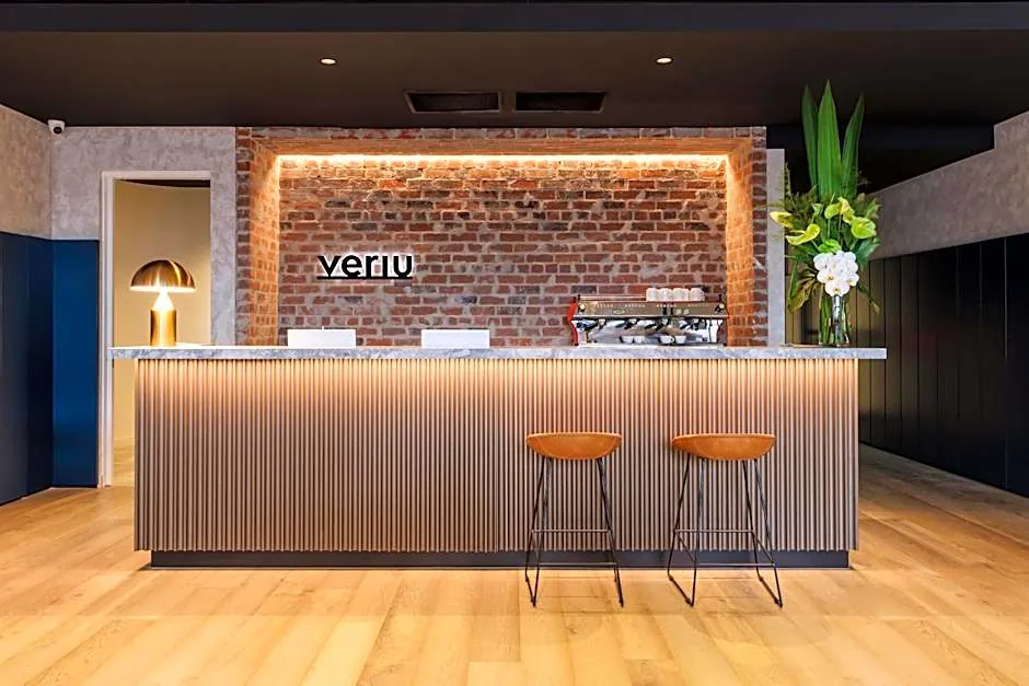 The warm brick-and-timber lobby at Veriu Collingwood